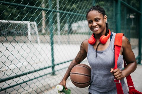 Woman doing a workout with basketball