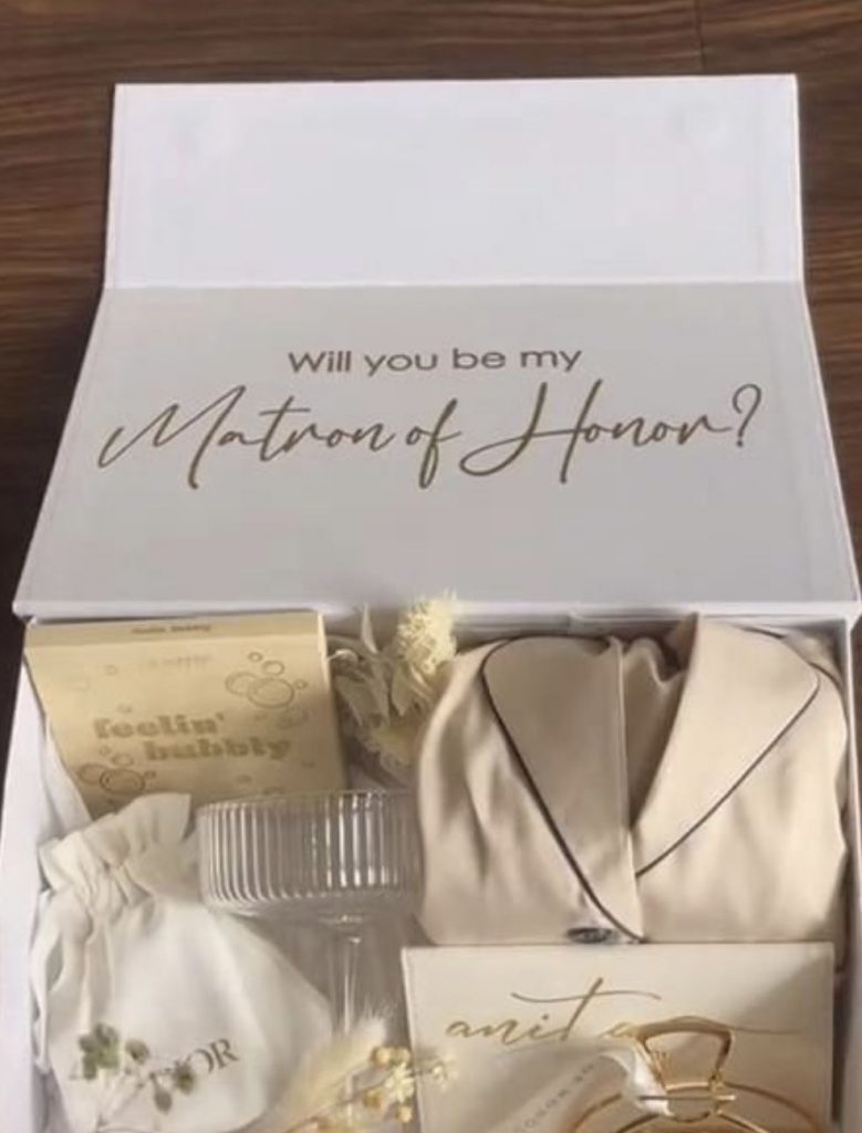 Matron of Honor proposal box with a cream aesthetic including pjs, a card, jewelry and a bracelet.