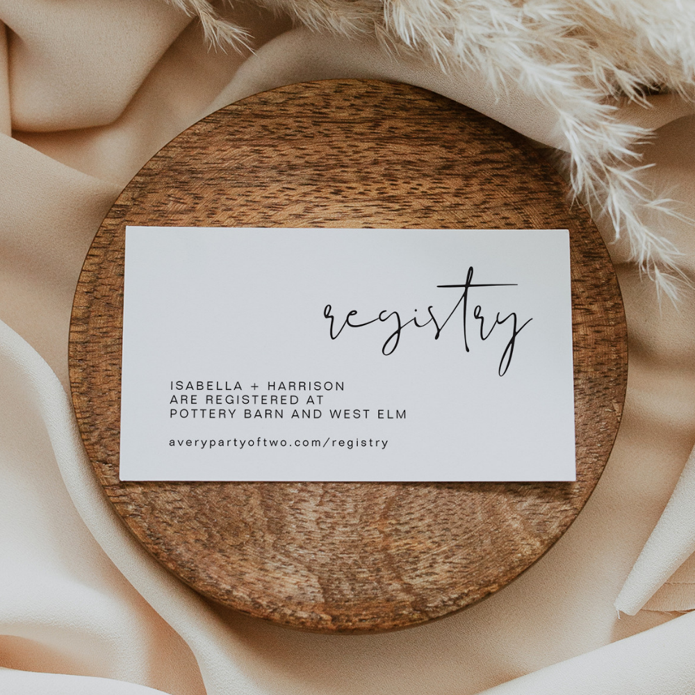A wedding registry card displayed on a wooden block, wrapped in silks.