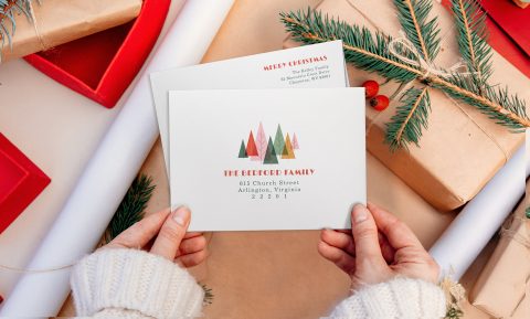 Hands holding Christmas envelope
