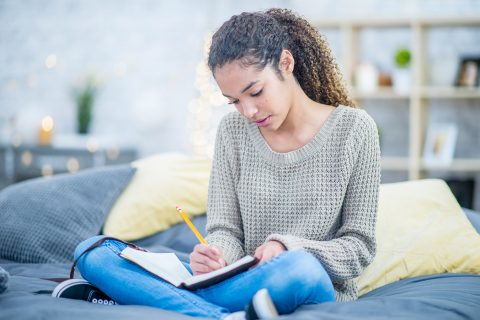 Girl writing in notebook