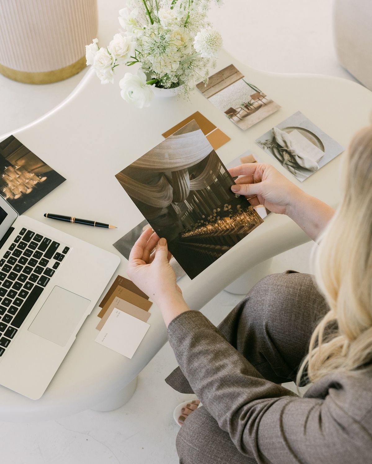 A wedding coordinator looks over venue images to help couples finalize the finer details of their wedding.
