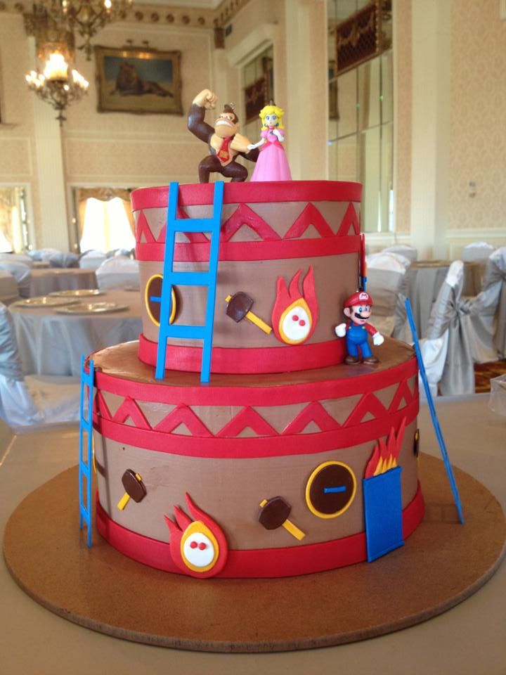 A red and blue wedding cake inspired by the video game Donkey Kong in a banquet hall.