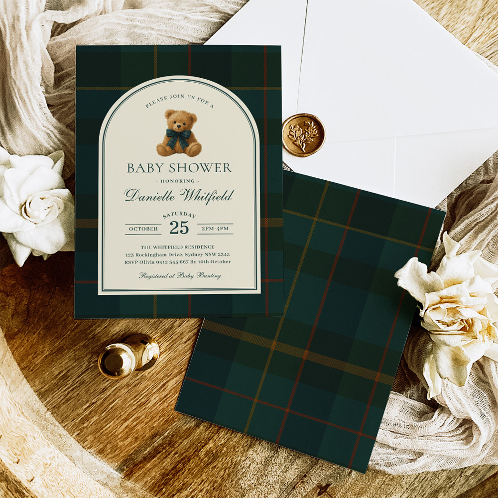 A baby shower invitation styled with a dark green plaid background, gold accents, and elegant typography. The design feels classic and preppy with a refined, traditional style.