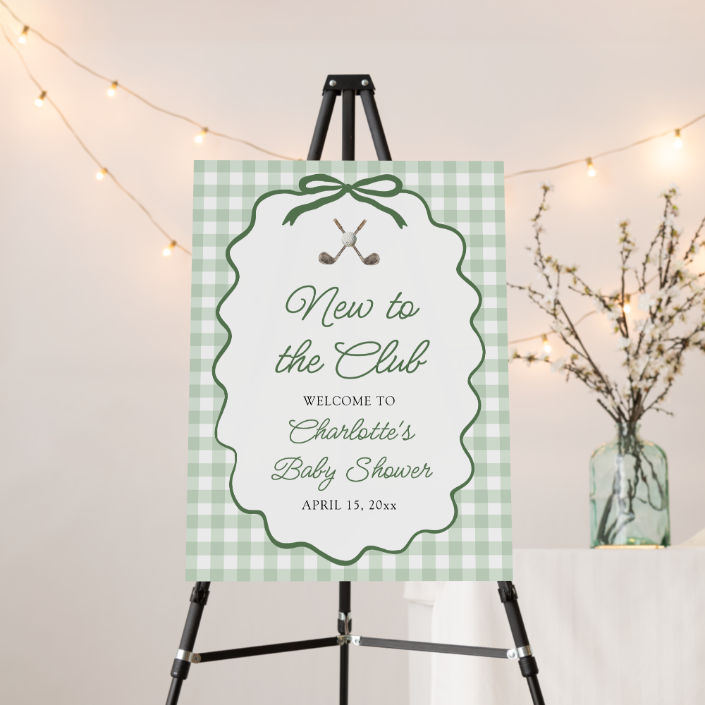 New to the Club golf-themed baby shower welcome sign on sage green gingham background with crossed golf clubs and decorative bow border, displayed on black easel with string lights and greenery.