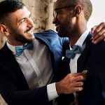 Newly married husbands are featured wearing matching dark blue/navy wedding suits.